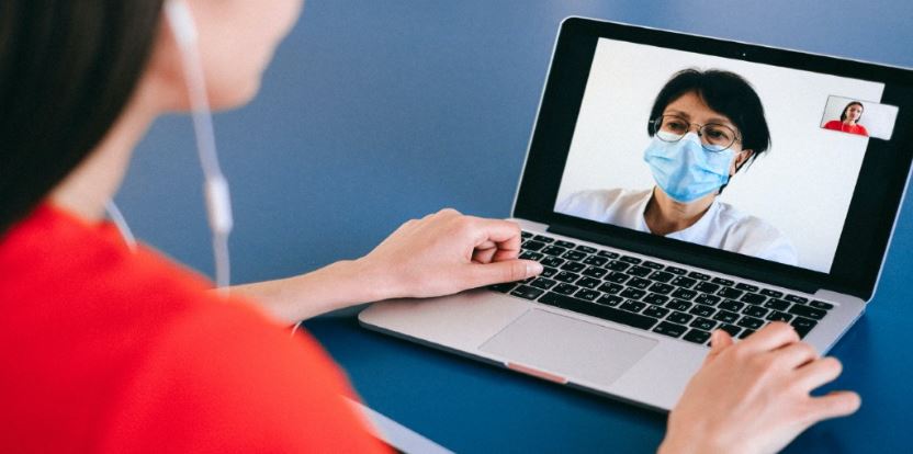 Woman in meeting with Doctor through Laptop