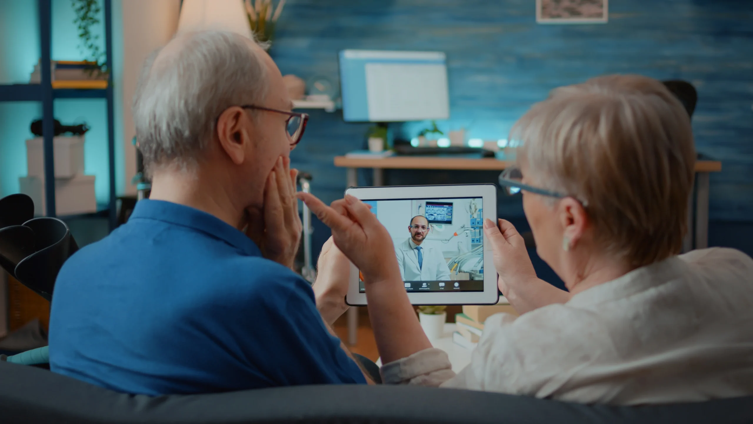 aged couples talking dentist online via software